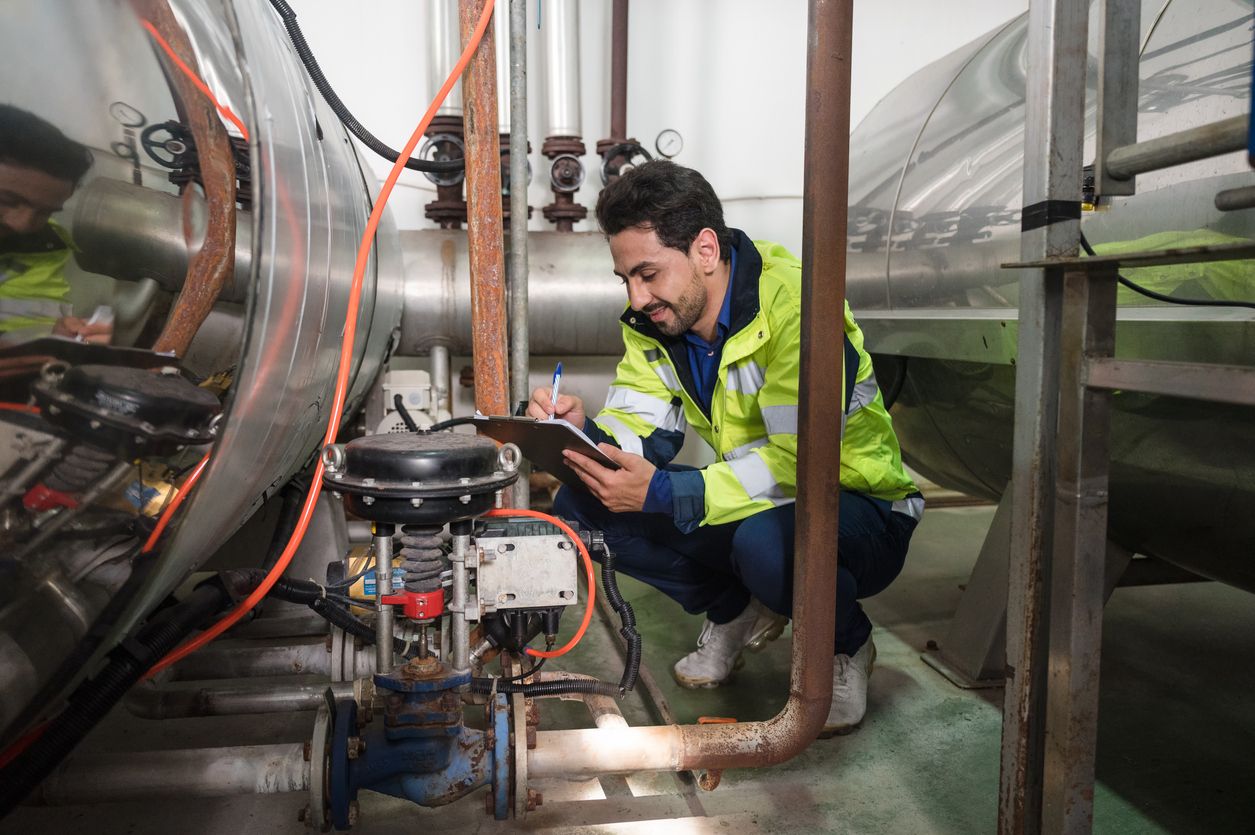 Building inspector with clipboard checking systems during a facility maintenance inspection